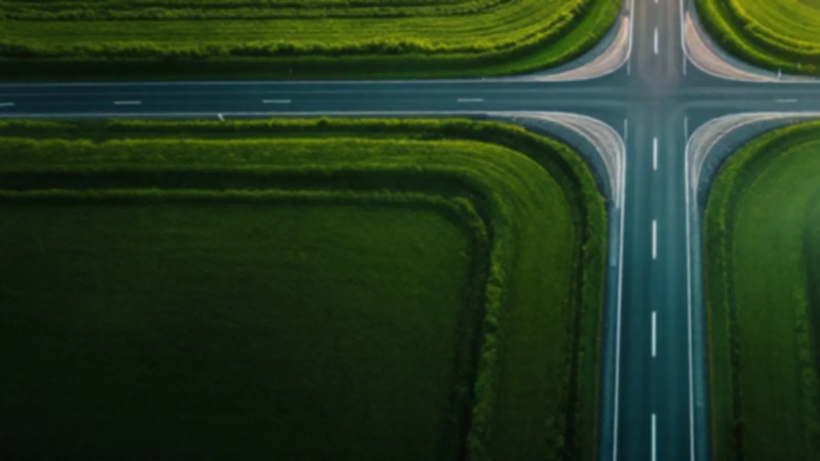 Aerial view of empty country roads crossing through green fields in morning mist, the AxleQuotes view of loan quotes online, $100 – $5,000
